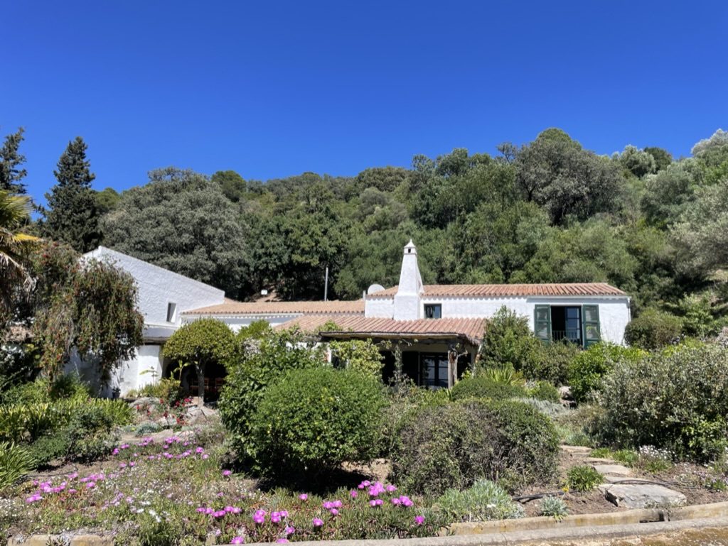 Los Nietos whitewashed farmhouse with flowering gardens and wooded hillside near Gaucín, Andalucía